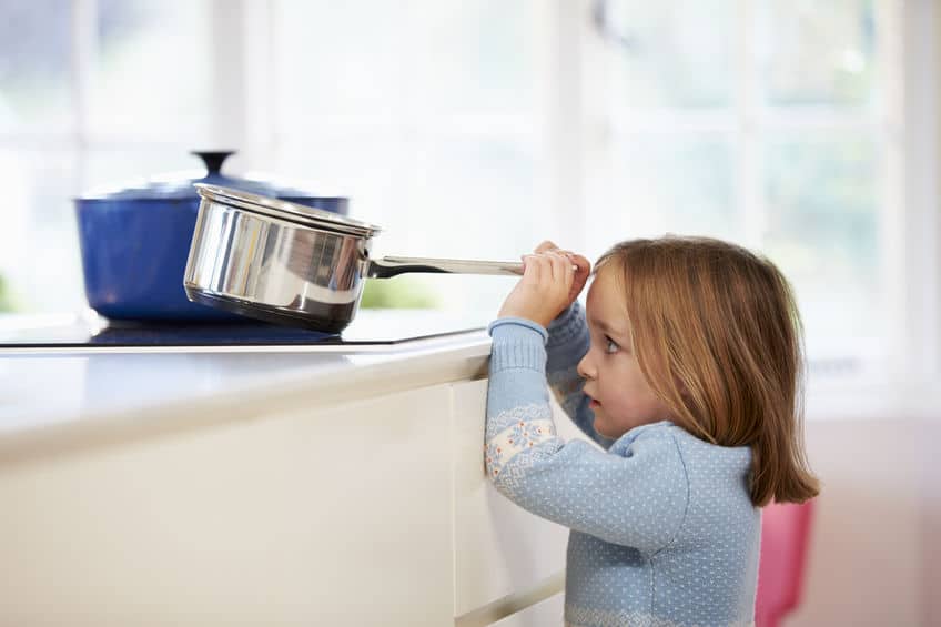 Young Girl Risking Accident With Pan In Kitchen