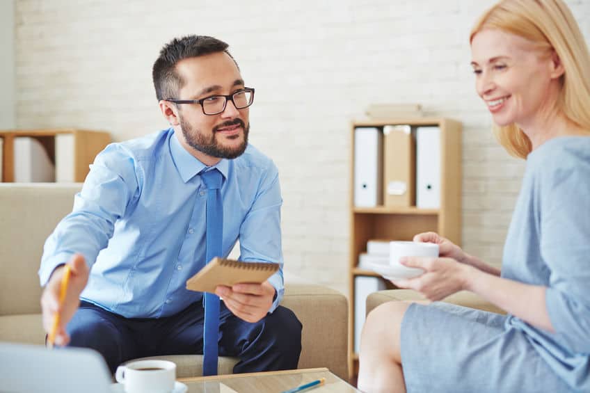 Salesman talking to female client